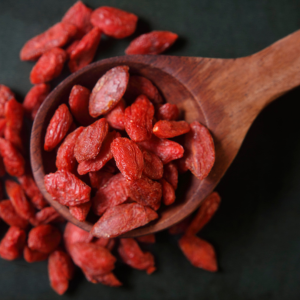 A wooden spoon filled with goji berries