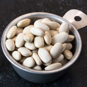 A metal bowl filled with white kidney beans