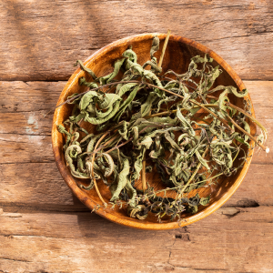 A wooden bowl filled with dried lemon verbena