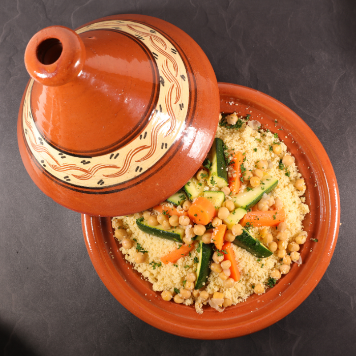 Couscous, chickpeas, cucumbers, and carrots in a ceramic dish