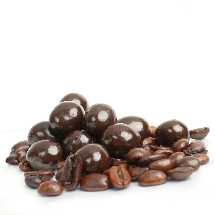 Dark chocolate covered coffee beans on a pile of coffee beans with a white background