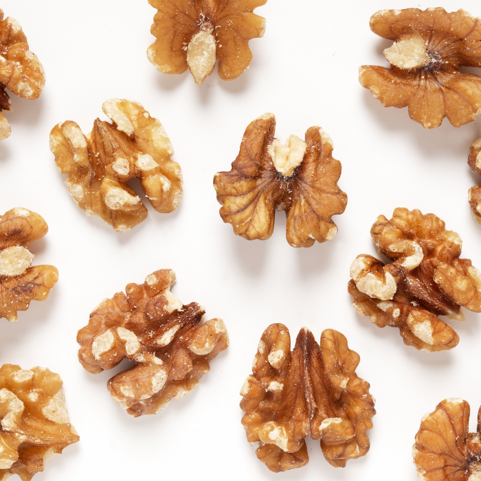 Walnut halves arranged on a white background