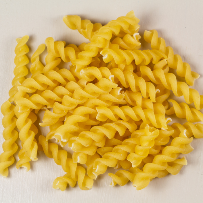 Wheat fusilli on a white background