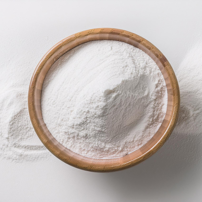 Zinc oxide powder in a wooden bowl on a white surface