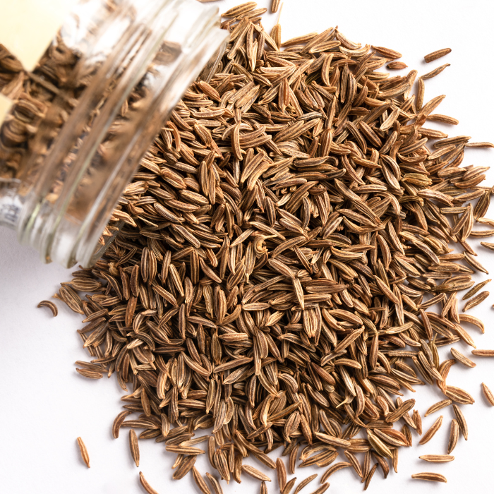 Whole caraway seeds on a white background