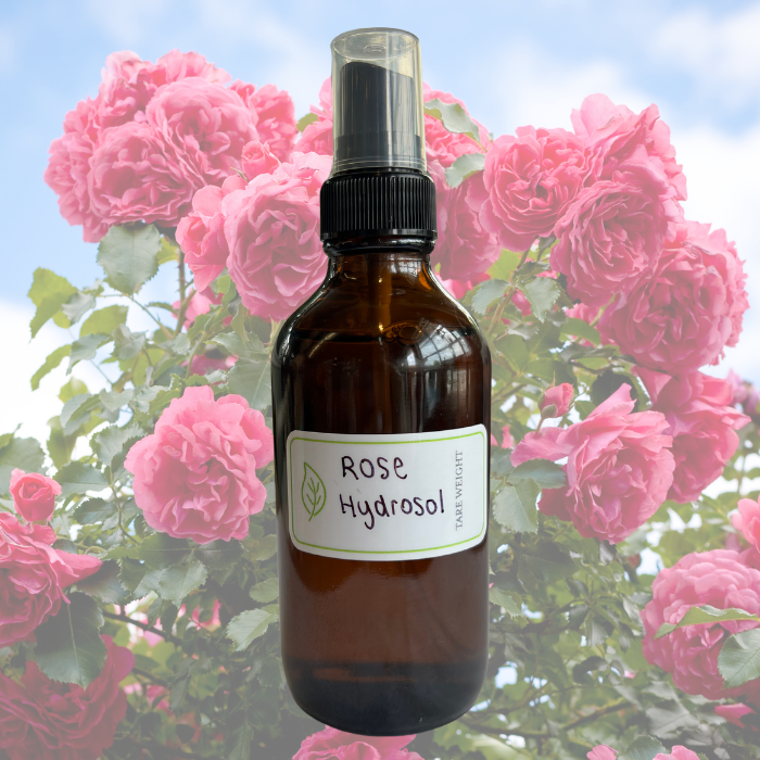 Rose hydrosol sprayer bottle on a background of faded roses