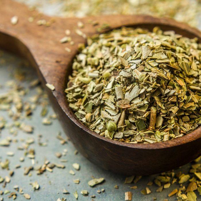 Dried basil in a wooden spoon