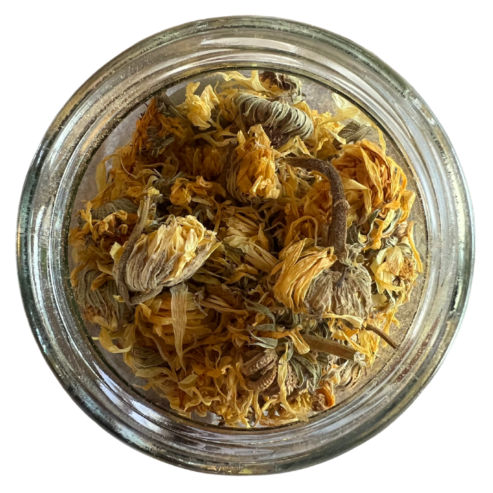 Whole calendula flowers in a clear glass jar with a white background