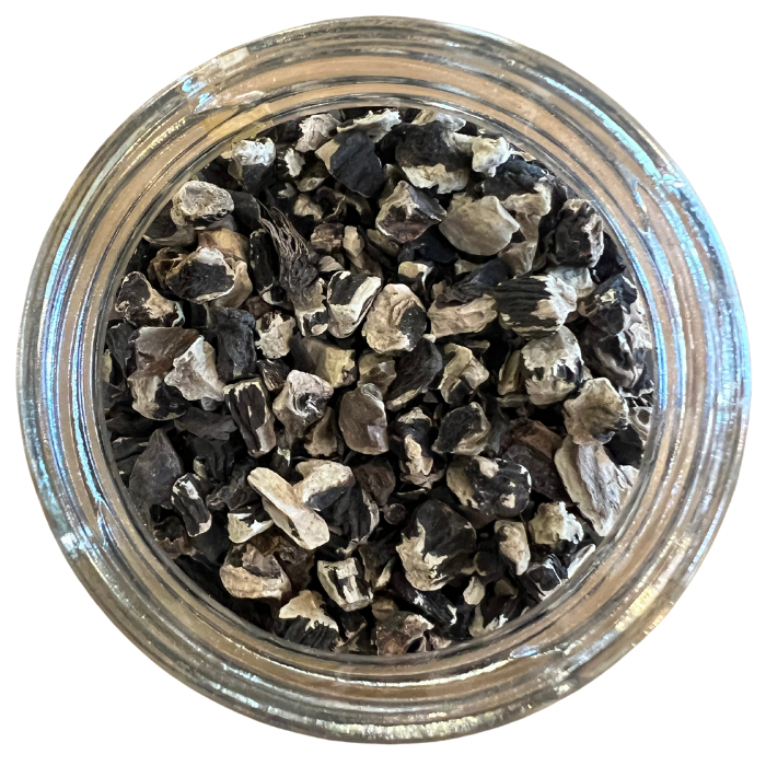 Comfrey root in a clear glass jar with a white background