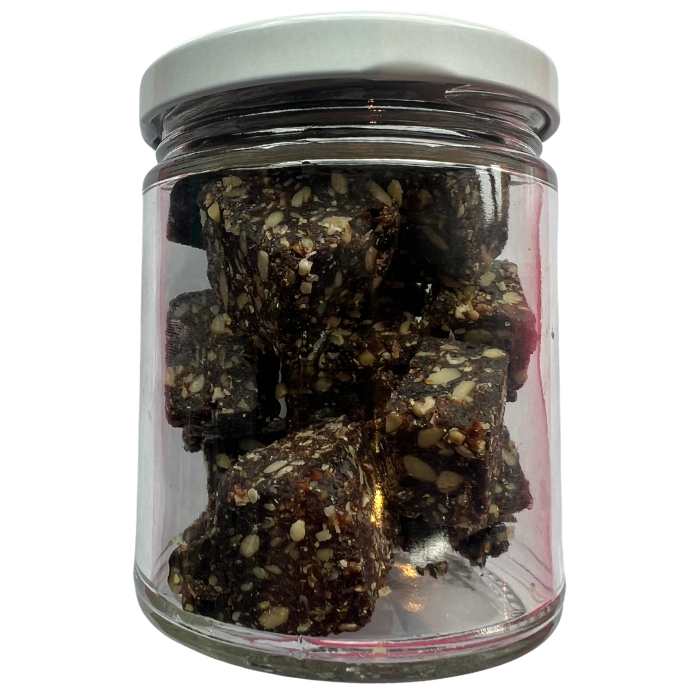 Energy nuggets in a glass jar with a white background