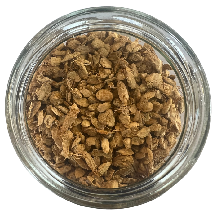 Dried ginger root in a glass jar with a white background