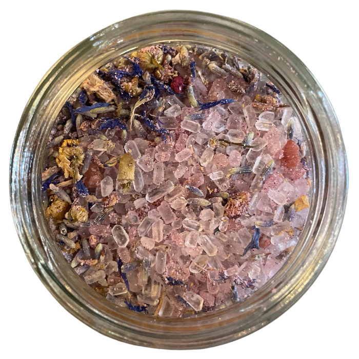 Lavender dream bath salts in a clear glass jar with a white background