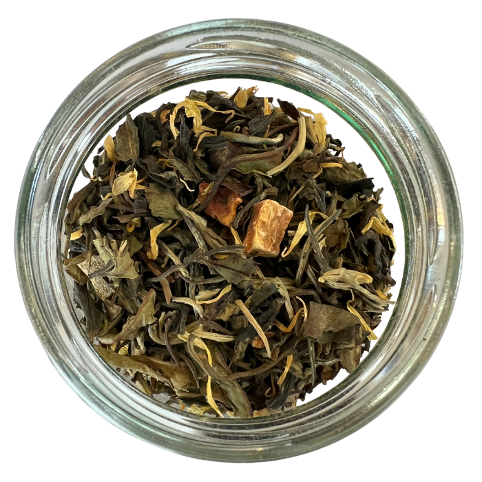 Monks blend white tea in a glass jar with a white background