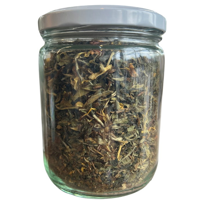 Monks blend white tea in a glass jar with a white background