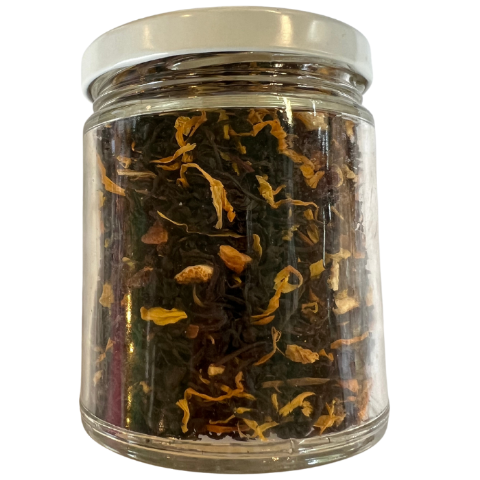 Pumpkin spice black tea in a glass jar with a white background