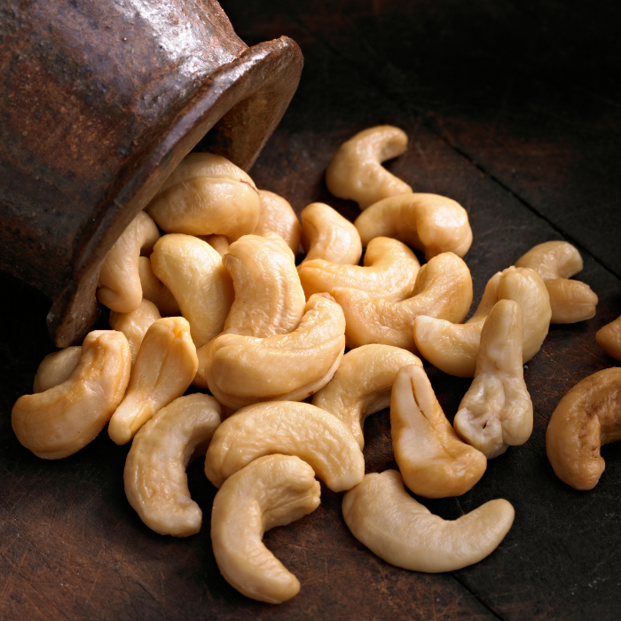 Whole cashews on a wooden background