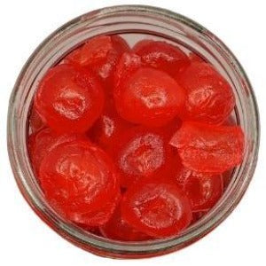 White background with a glass jar filled with Glacé Cherries (red or green).