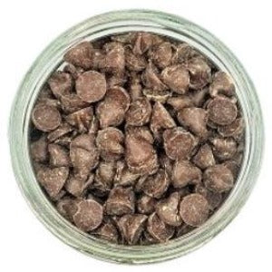 White background with a glass jar filled with Organic Vegan Carob Chips. 